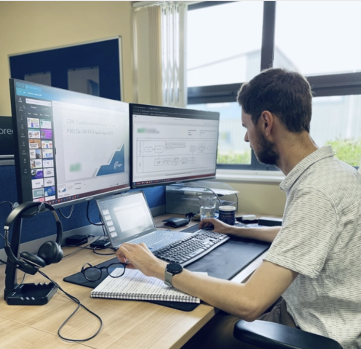 PSP software tester working at his computer with multiple screens.