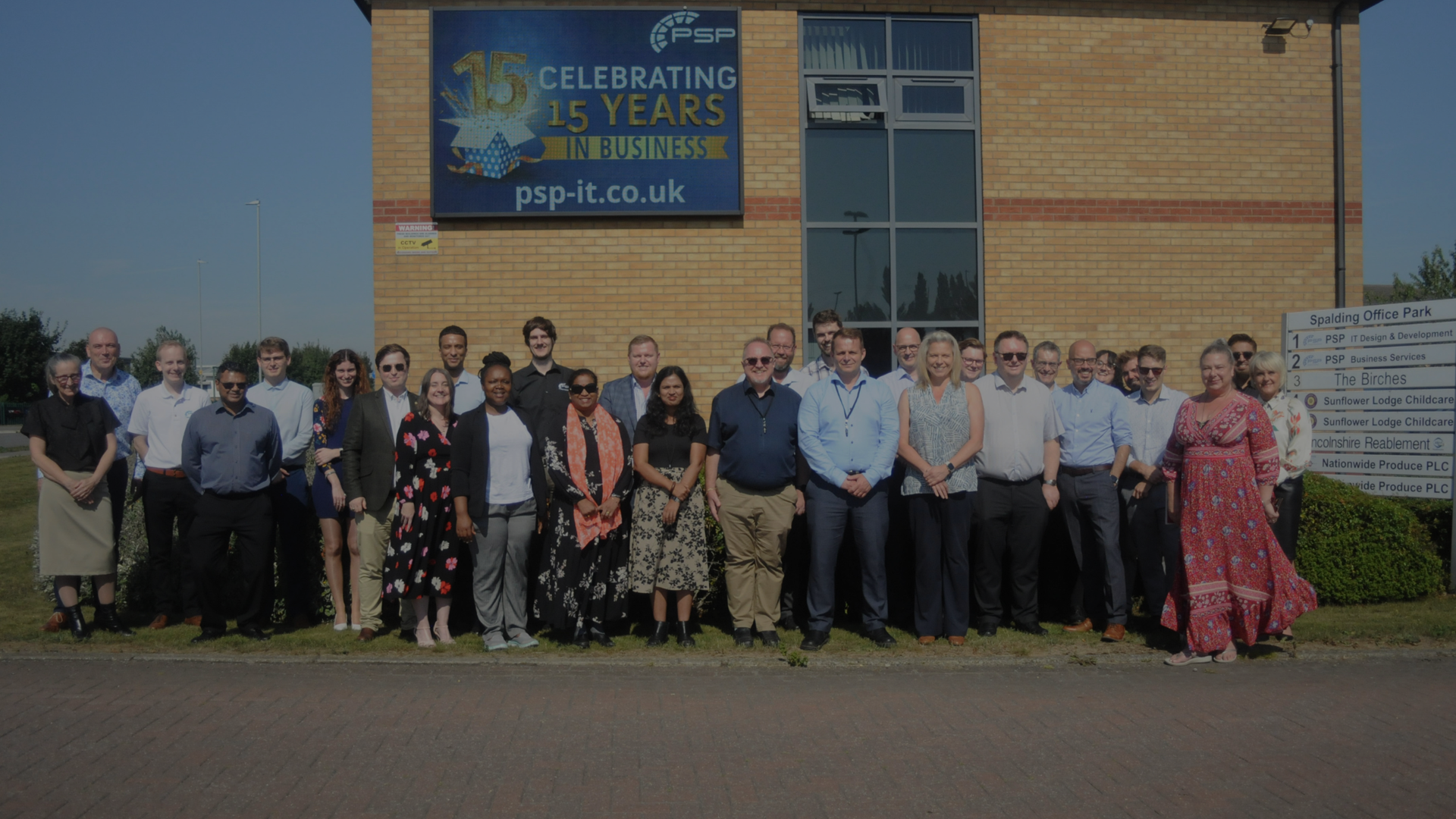 PSP IT's staff outside their offices celebrating their 15th birthday. 