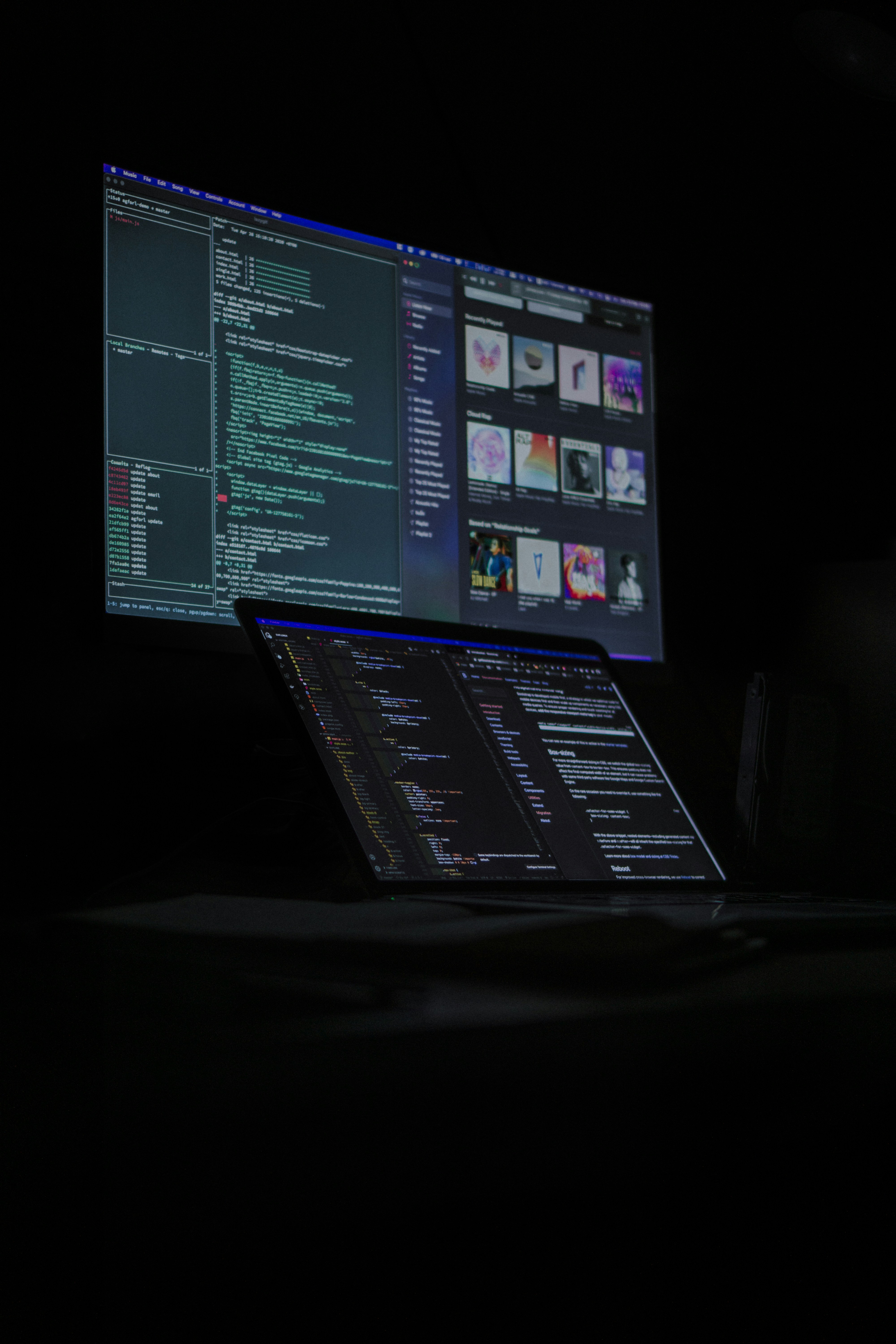 A computer and tablet with code displayed on both as they are in the process of a website integration. 