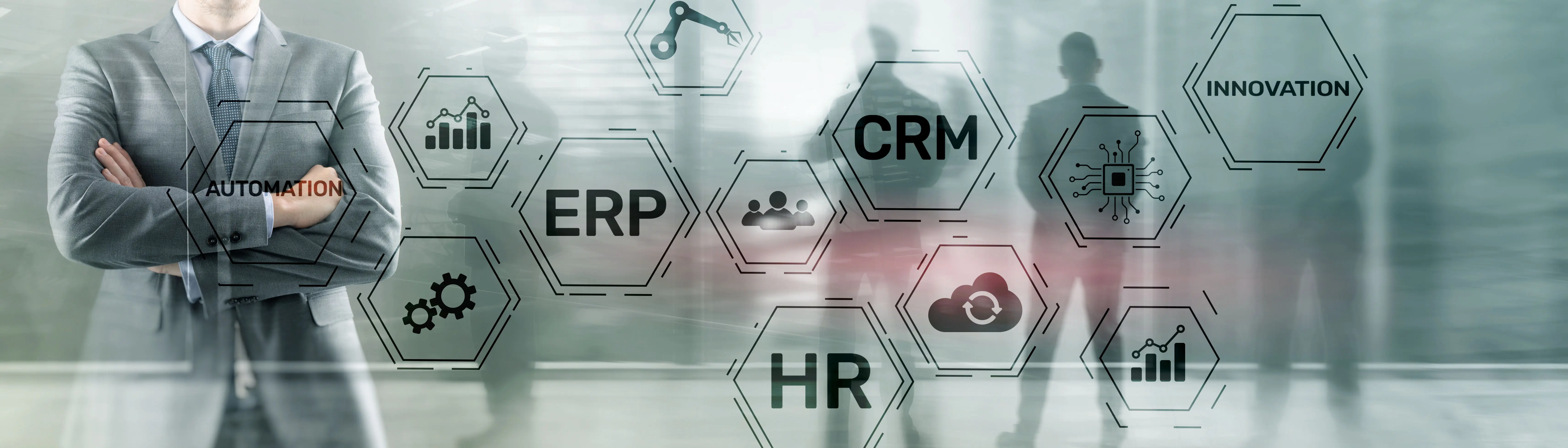 A man in a suit with a clear opaque screen behind him with ERP, CRM and HR written on it.