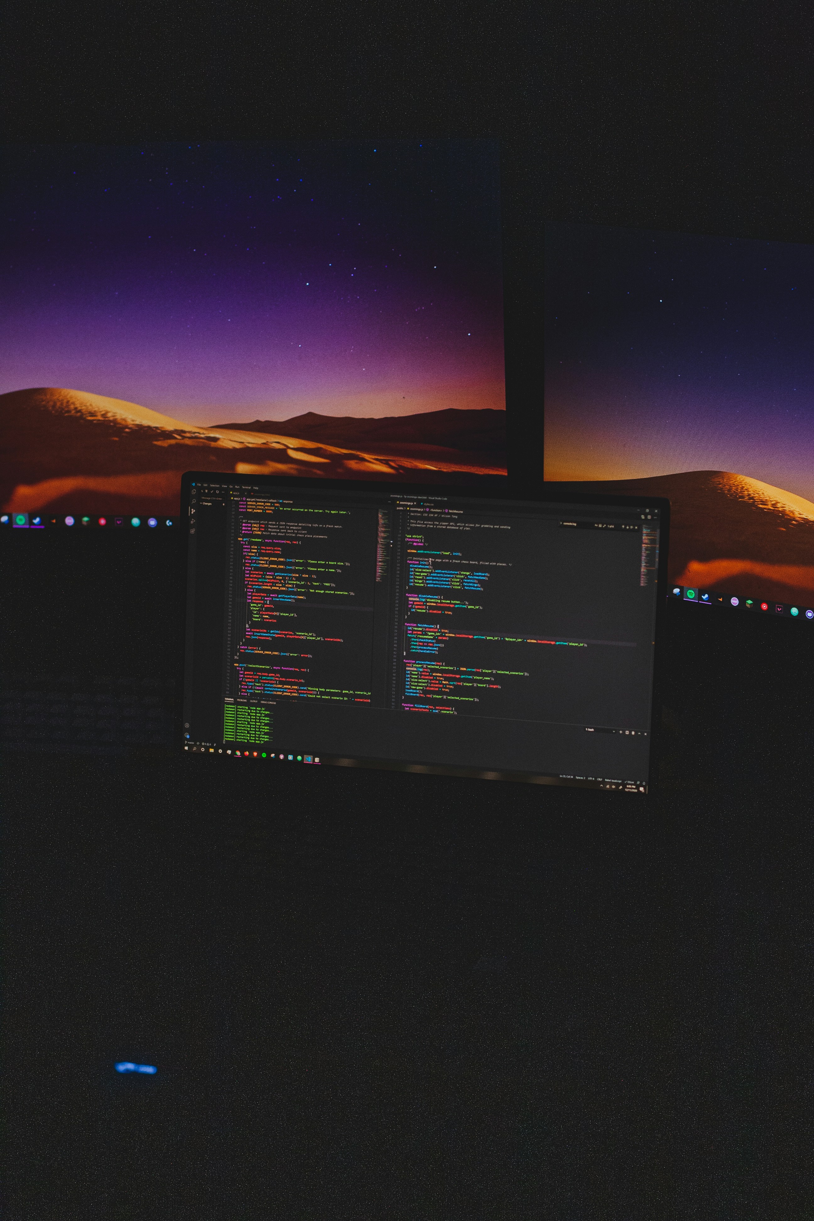 Digital Transformation on a legacy system to modernise it with code on one of three computer screens.