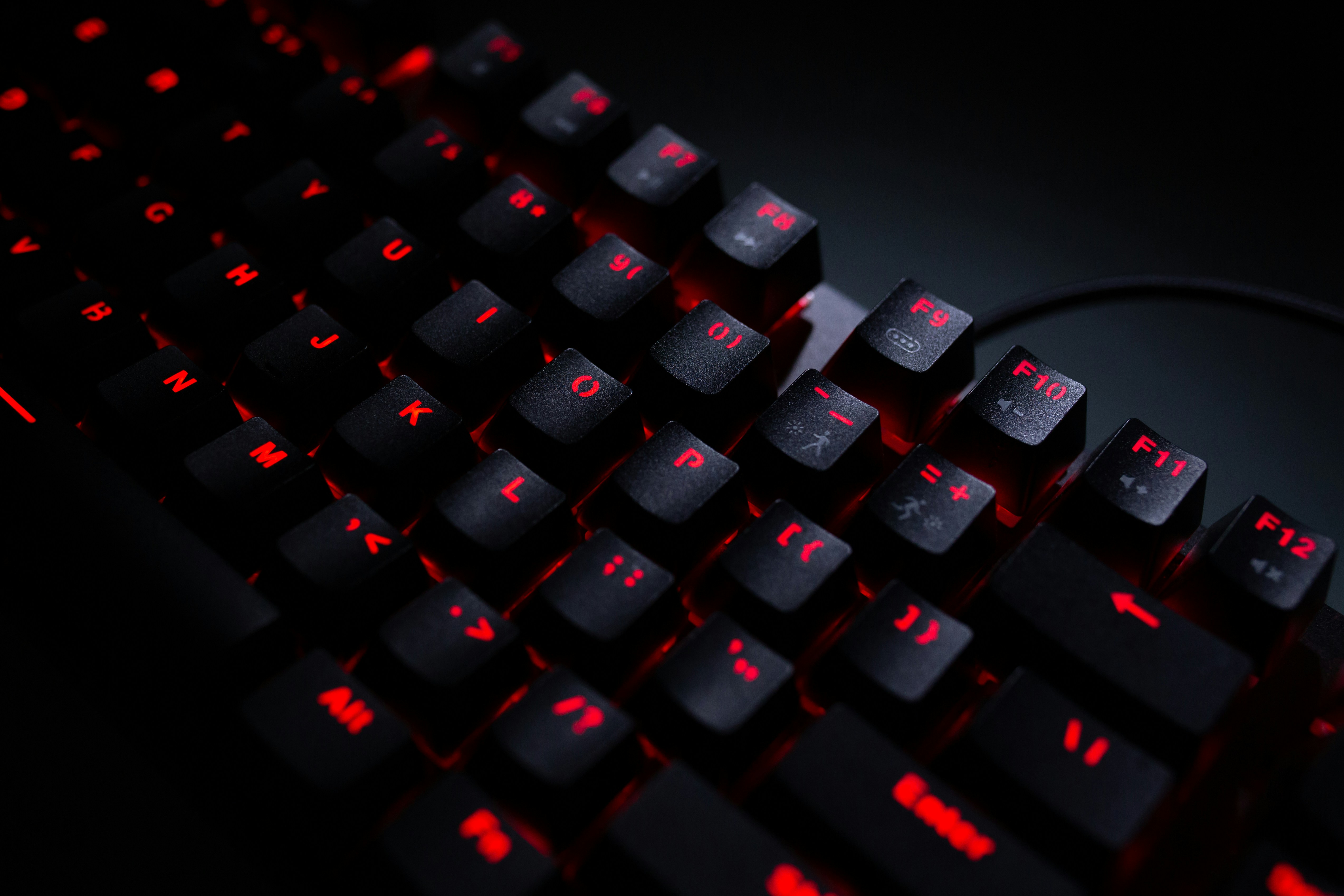 An old legacy system keyboard in black with red keys lighting up